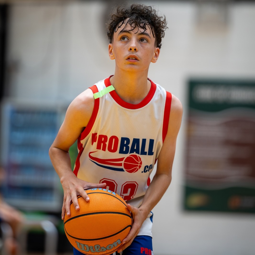 Young basketball athlete in Sydney hesitating during a game while learning confidence and emotional resilience through sport.