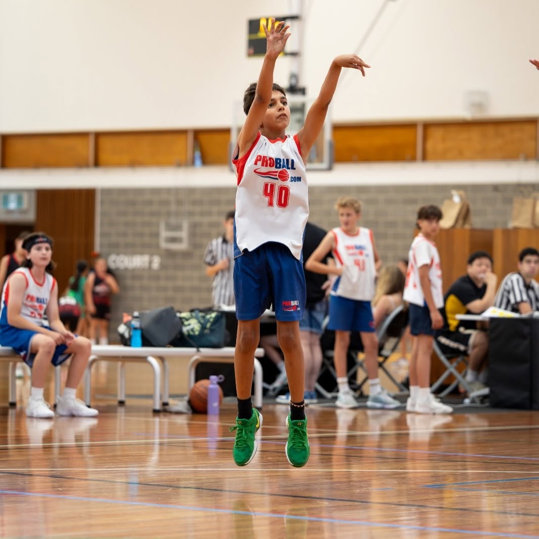 ProBall youth basketball player listening to coach instructions during a team training session in Sydney.