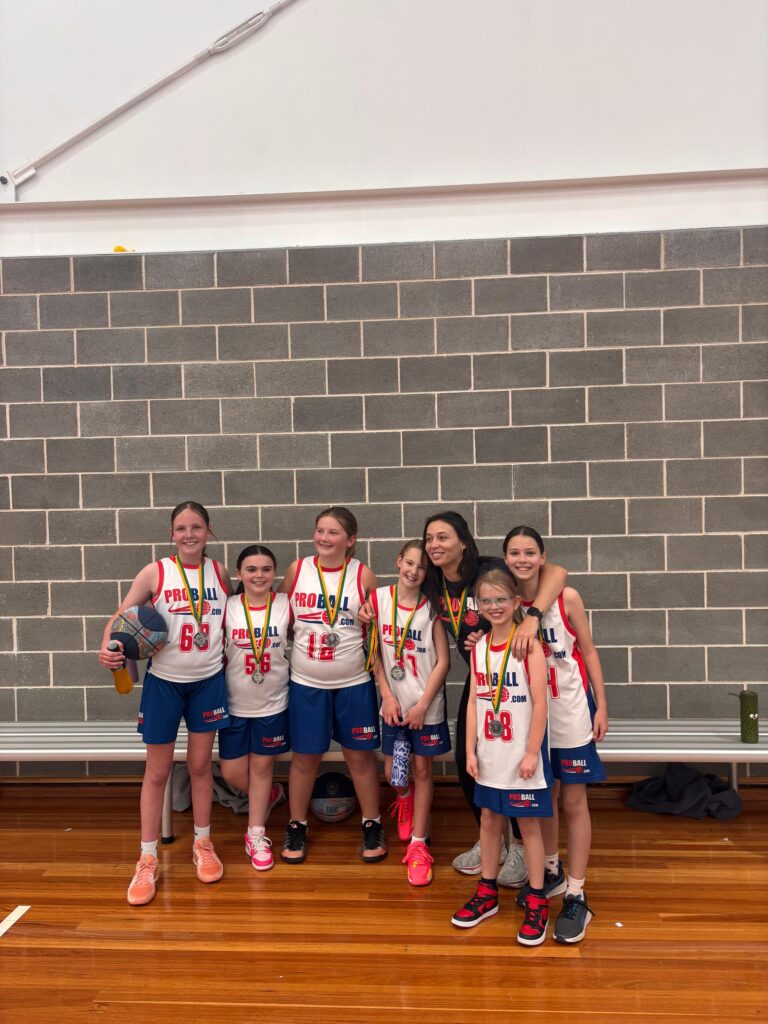 ProBall girls basketball players smiling and shouting ‘ProBall’ together at the end of their training session in Sydney.
